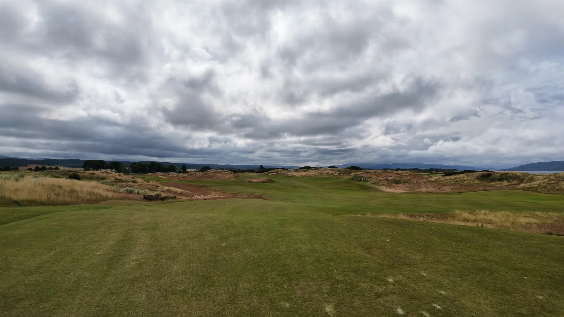 Rolling fairways beneath a dramatic Scottish sky