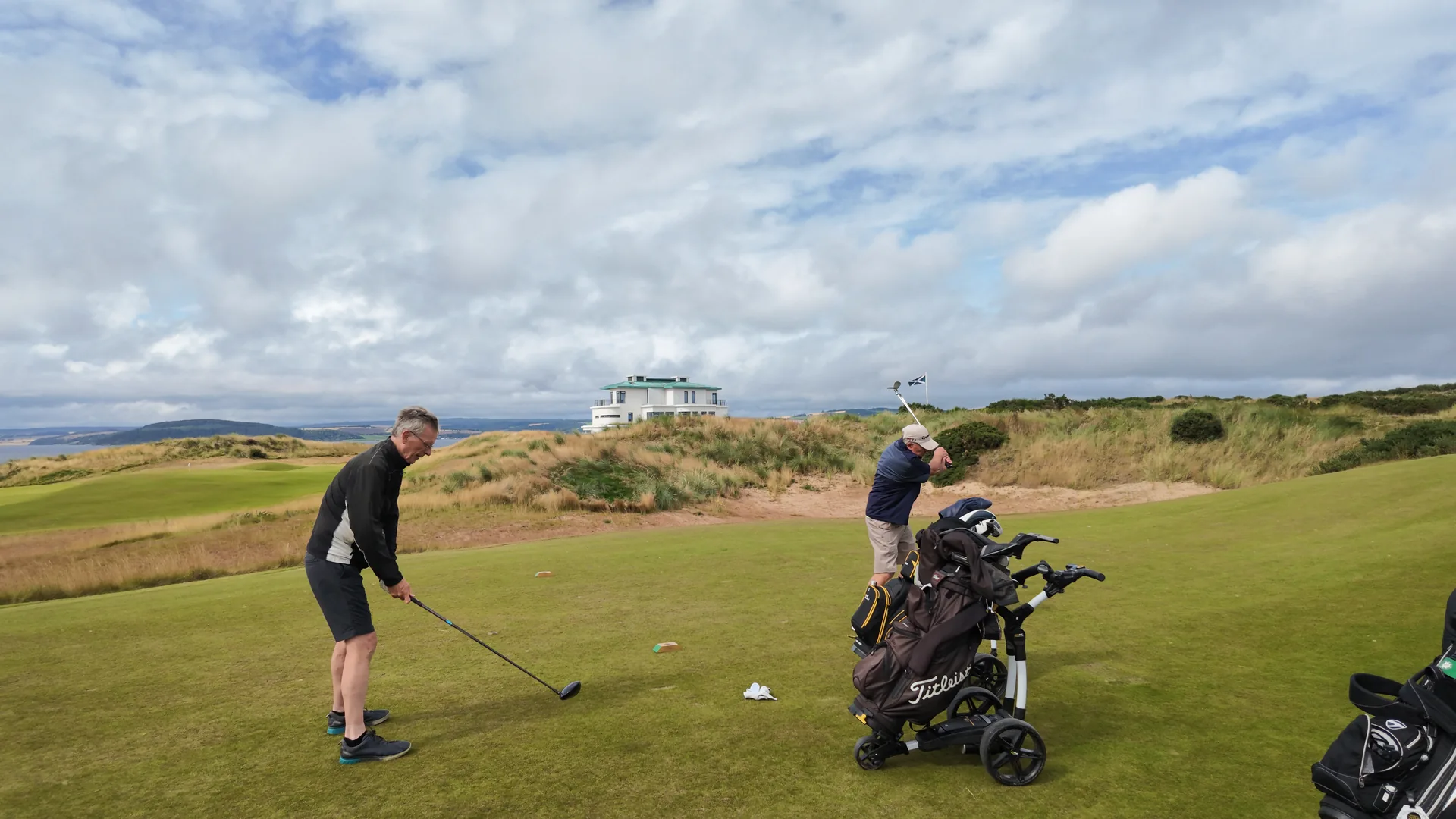 Golfers preparing a shot on the fairway